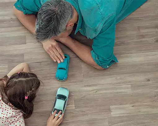 Dad and daughter playing toys | Legend Flooring